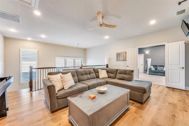 a living room with furniture and a wooden floor