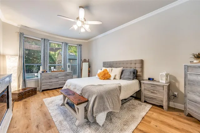 a bedroom with a large bed and a chandelier