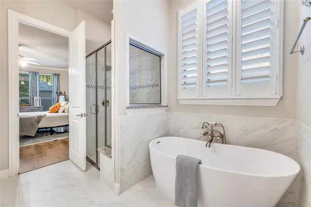 a spacious bathroom with a bathtub and next to a window