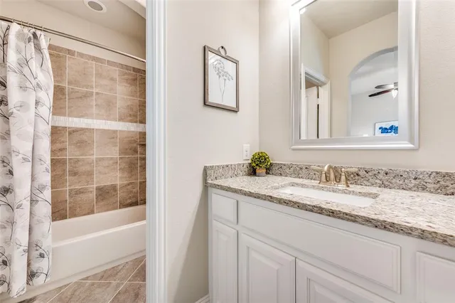 a bathroom with a granite countertop sink a mirror a