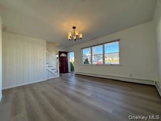 29 Arizona Avenue Syosset, NY 11791 - Photo 13 of 26 an empty room with wooden floor chandelier and windows