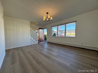 29 Arizona Avenue Syosset, NY 11791 - Photo 9 of 26 wooden floor in an empty room with a window