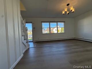 29 Arizona Avenue Syosset, NY 11791 - Photo 10 of 26 an empty room with wooden floor and windows