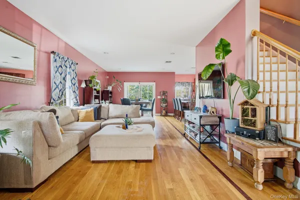 a living room with furniture fireplace and a large window