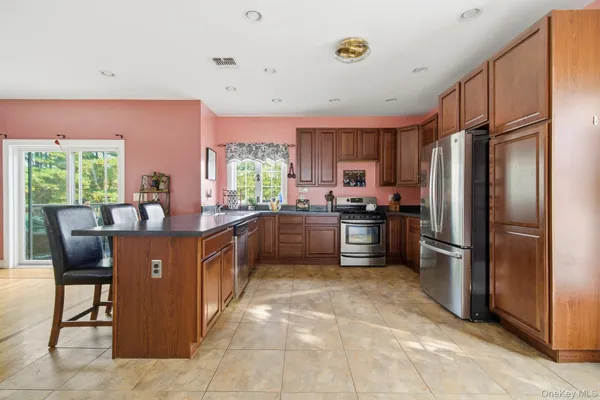 a kitchen with stainless steel appliances a refrigerator sink and cabinets