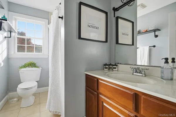 a bathroom with a toilet sink and mirror