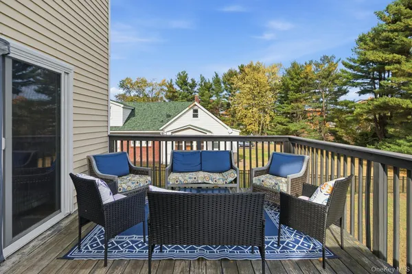 a view of a chairs and table on the deck