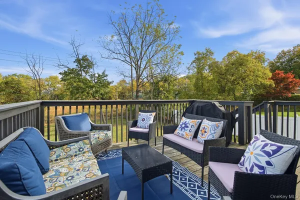 a view of a roof deck with furniture