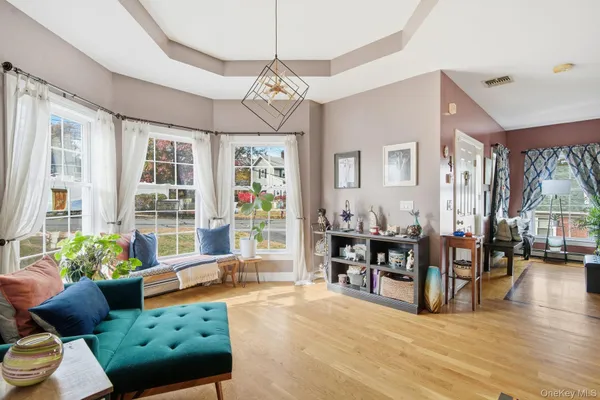 a living room with furniture and a dining table