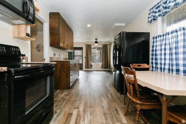 1105 Litz Road Preston, ID 83263 - Photo 10 of 24 Kitchen featuring black appliances, light wood-style floors, a ceiling fan, granite countertops and recessed lighting
