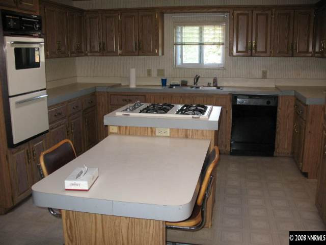1525 Moon Lane Reno, NV 89521 - Photo 3 of 6 a kitchen with a stove a sink and a microwave