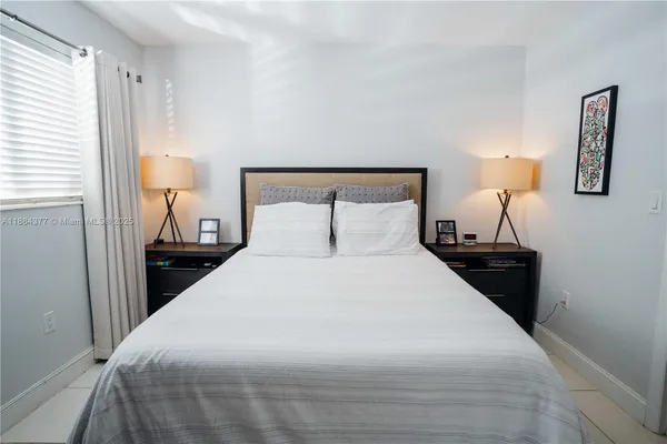 a bedroom with a bed and a lamp