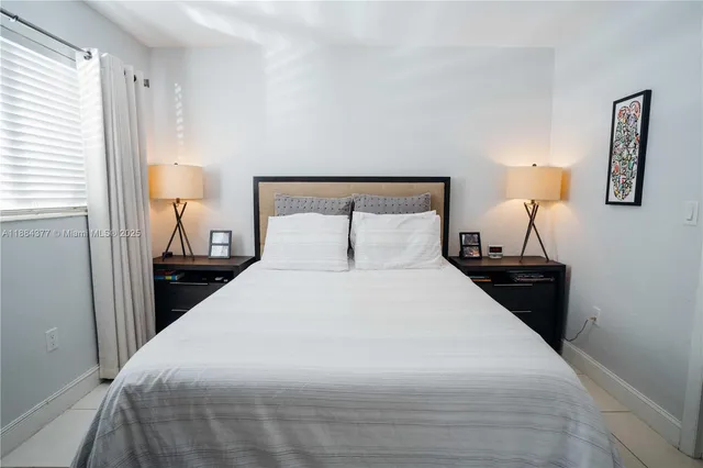 a bedroom with a bed and a lamp