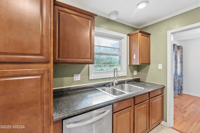 a kitchen with a sink cabinets and window