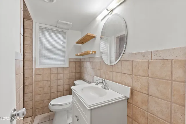 a bathroom with a sink toilet and mirror