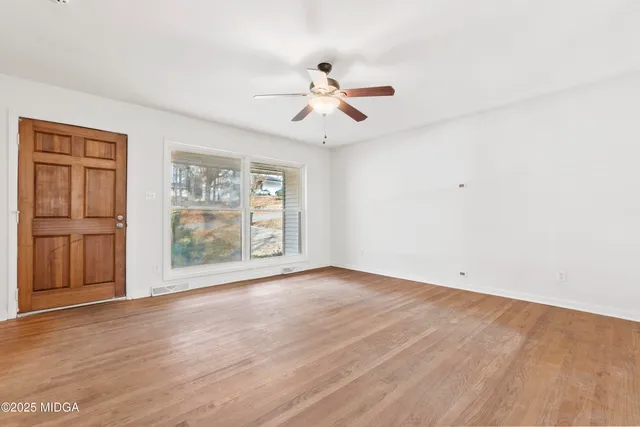 wooden floor in an empty room with a window