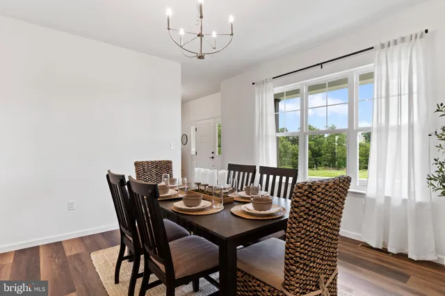 a hallway with wooden floor and stairs