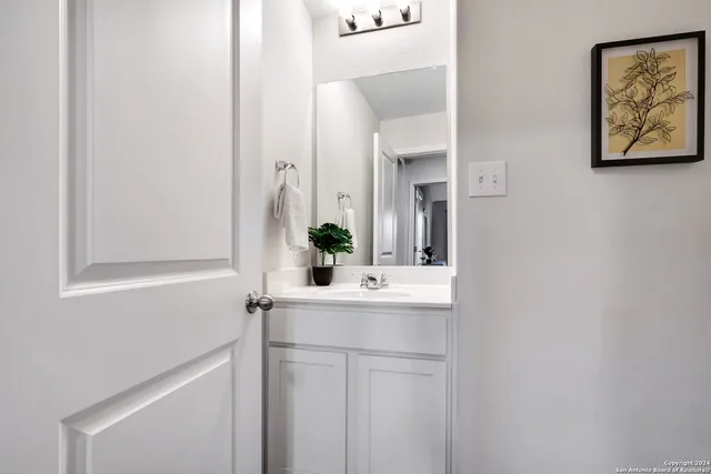 a bedroom with a bed lamp and a large window