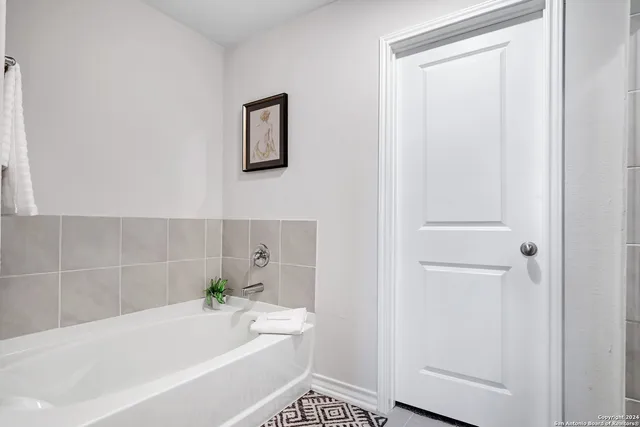a bathroom with a bathtub and a shower