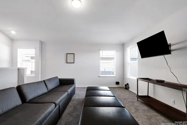 a large bedroom with a bed and a window