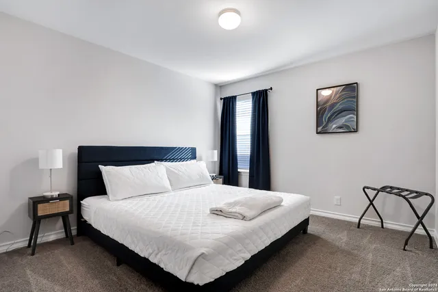 a large bed sitting in a bedroom with lamp