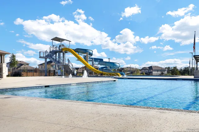 a living room with furniture flat screen tv and a large window