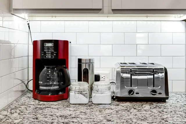 a kitchen with stainless steel appliances a stove top oven a sink dishwasher and a refrigerator