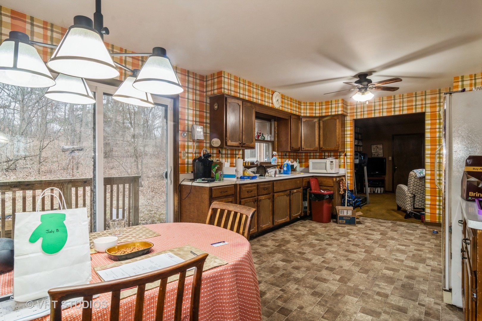 42W668 Pouley Road Elburn, IL 60119 - Photo 11 of 31 a kitchen with stainless steel appliances kitchen island granite countertop a refrigerator a stove a sink a dining table and chairs with wooden floor