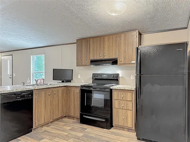 a kitchen with a sink stove and refrigerator