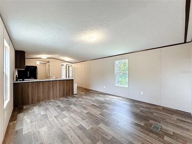 a view of kitchen with furniture and wooden floor