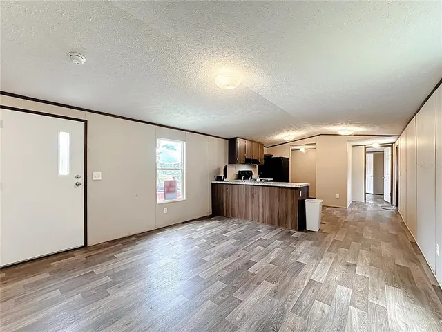 a view of a kitchen with a sink and a refrigerator