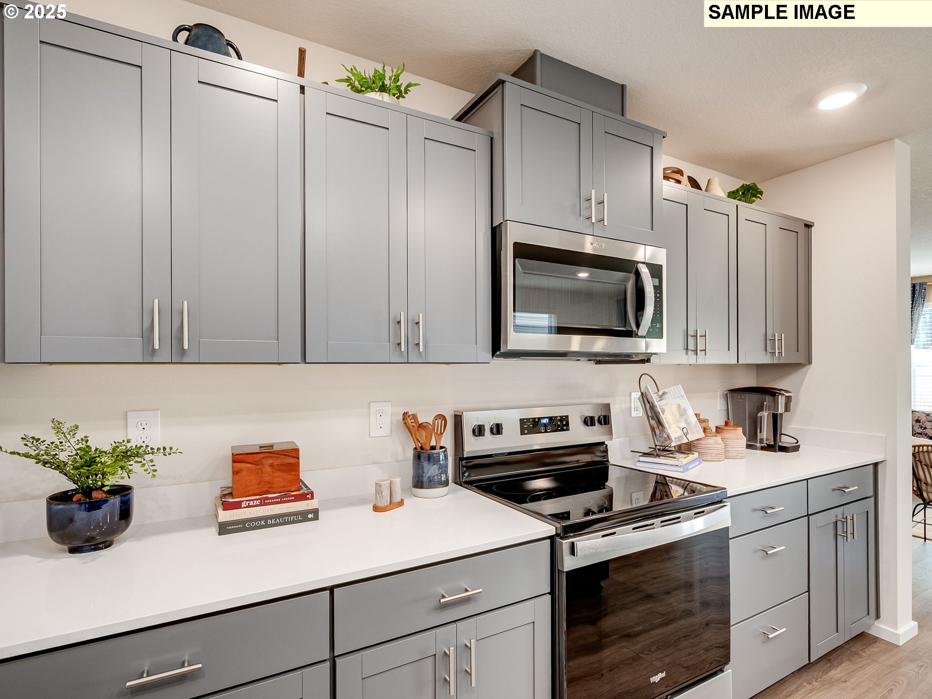 11206 Southeast Maxon Road Vancouver, WA 98664 - Photo 7 of 31 a kitchen with stainless steel appliances a stove a sink cabinets and a microwave