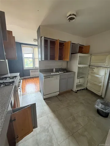 a kitchen with stainless steel appliances granite countertop a sink and a stove next to a window