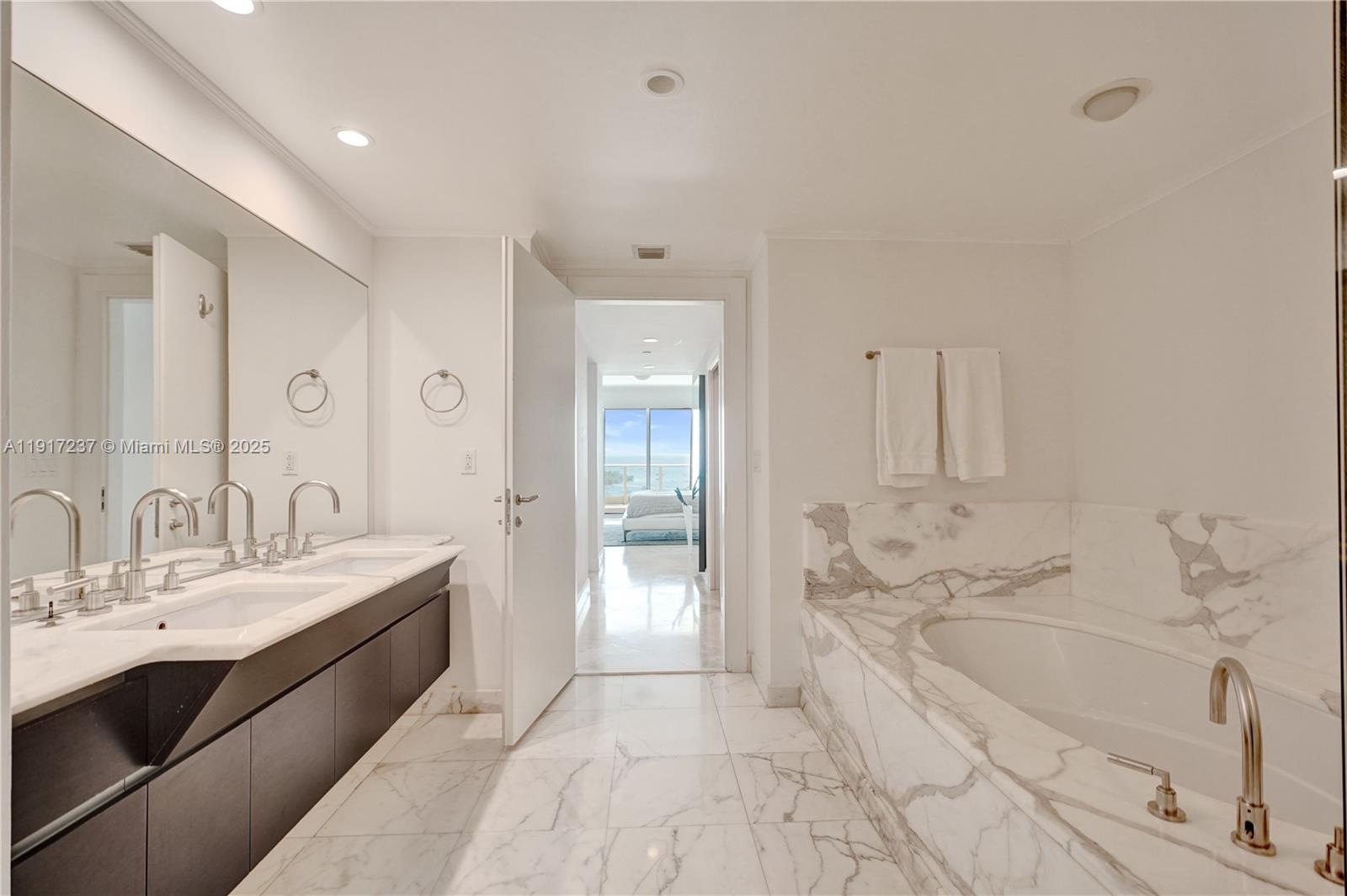 2627 South Bayshore Drive, Unit 1806 Miami, FL 33133 - Photo 13 of 33 a spacious bathroom with a bathtub sink and mirror
