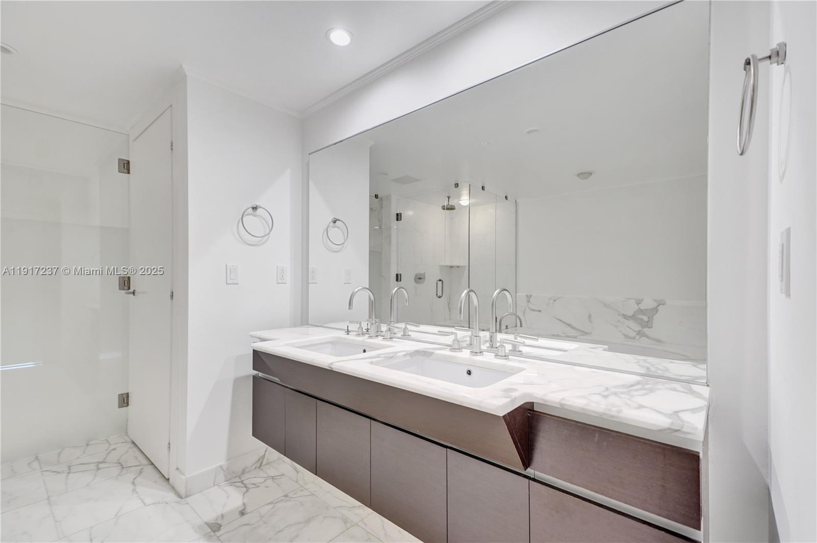 2627 South Bayshore Drive, Unit 1806 Miami, FL 33133 - Photo 16 of 33 a bathroom with a sink and a mirror