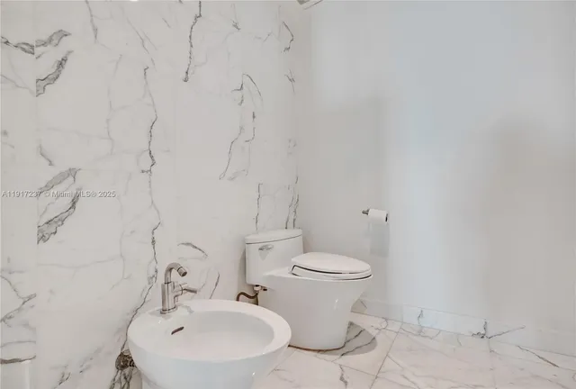 a bedroom with a bed and large window