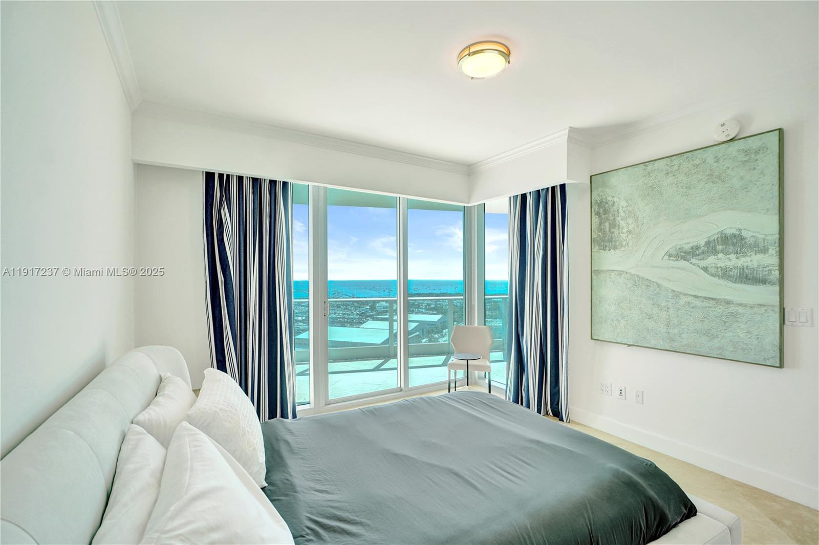 2627 South Bayshore Drive, Unit 1806 Miami, FL 33133 - Photo 22 of 33 a bedroom with a large bed and a painting on the wall