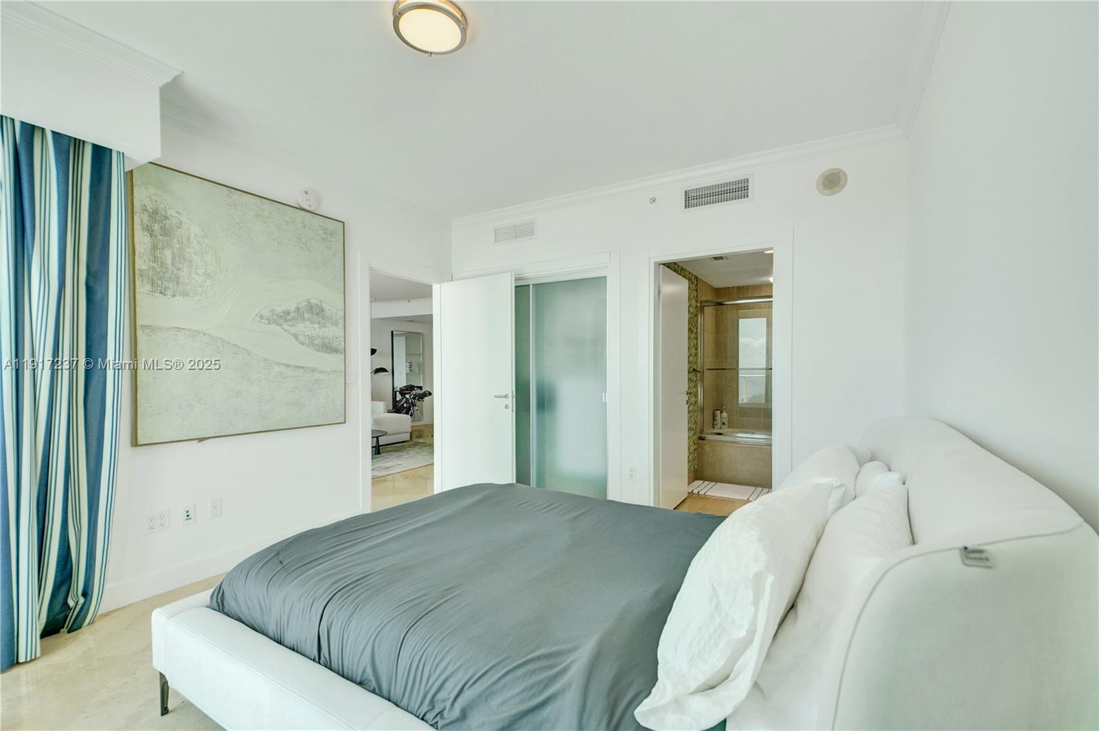 2627 South Bayshore Drive, Unit 1806 Miami, FL 33133 - Photo 23 of 33 a bedroom with a bed and a painting on the wall