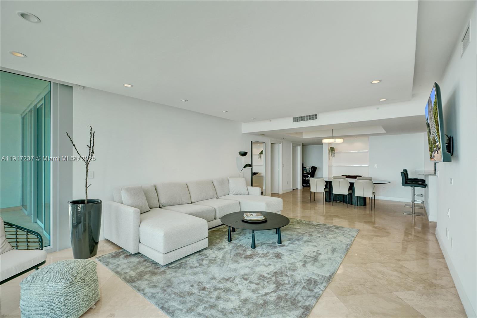 2627 South Bayshore Drive, Unit 1806 Miami, FL 33133 - Photo 10 of 33 a living room with furniture and a rug