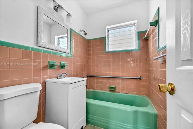 a bathroom with a toilet sink and mirror