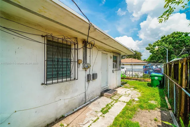 a view of house with backyard