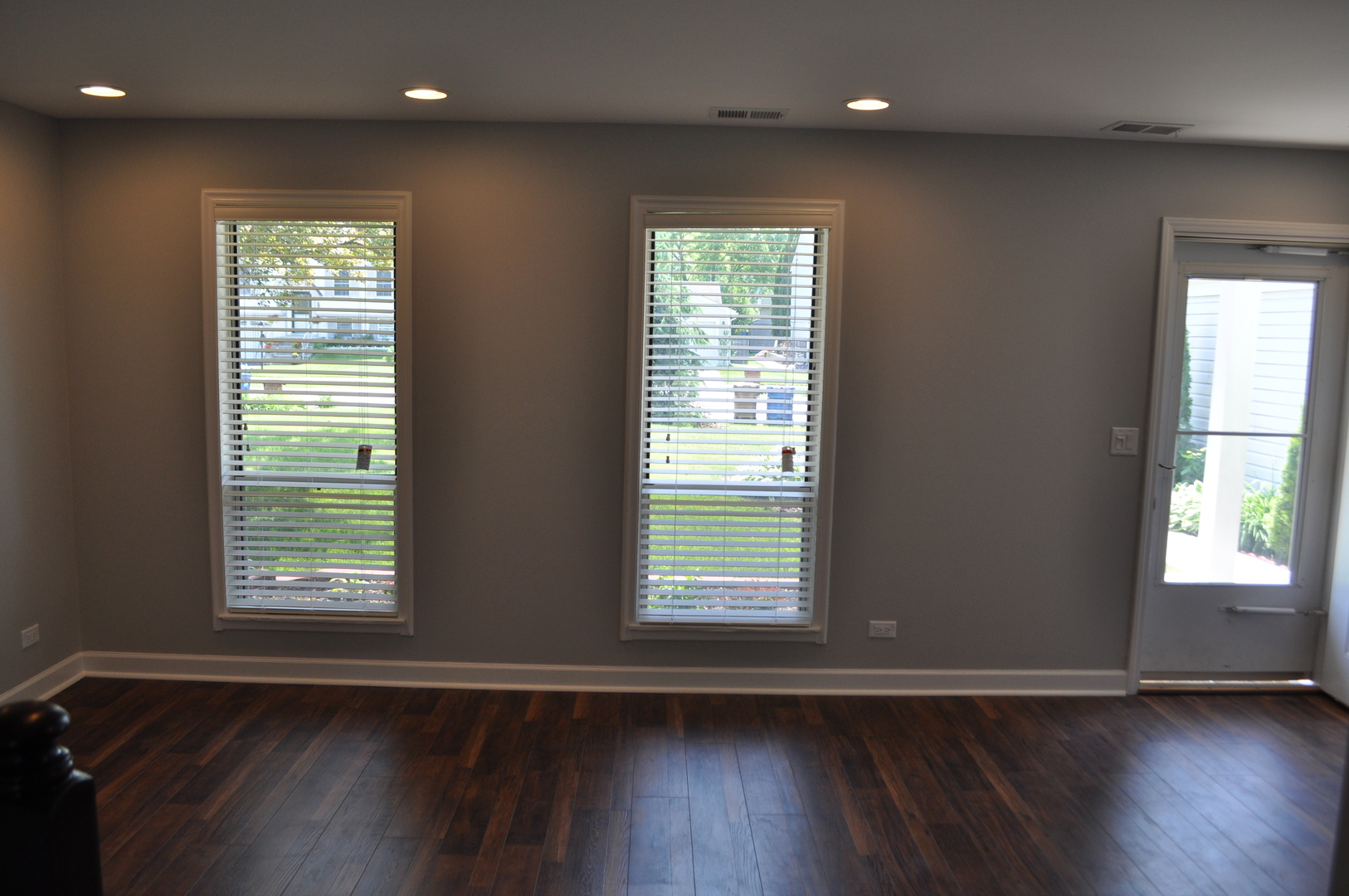 394 Rodenburg Road Roselle, IL 60172 - Photo 4 of 28 an empty room with wooden floor and windows