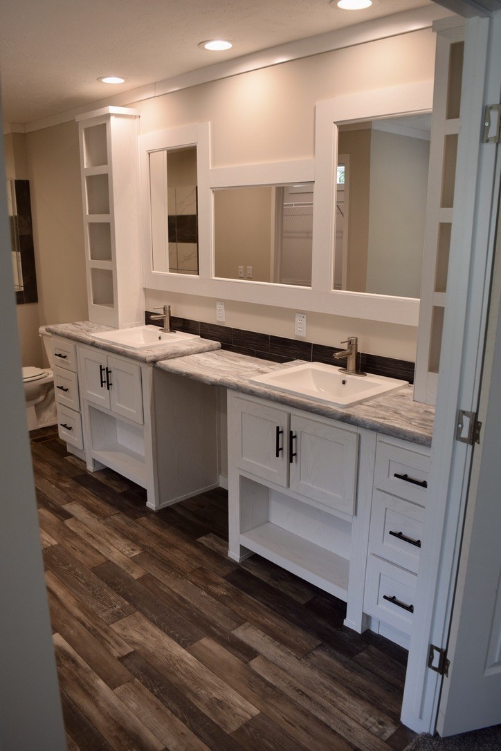 2166 Shrum Cemetery Road Westmoreland, TN 37186 - Photo 19 of 32 a bathroom with a double vanity sink a mirror and a bathtub