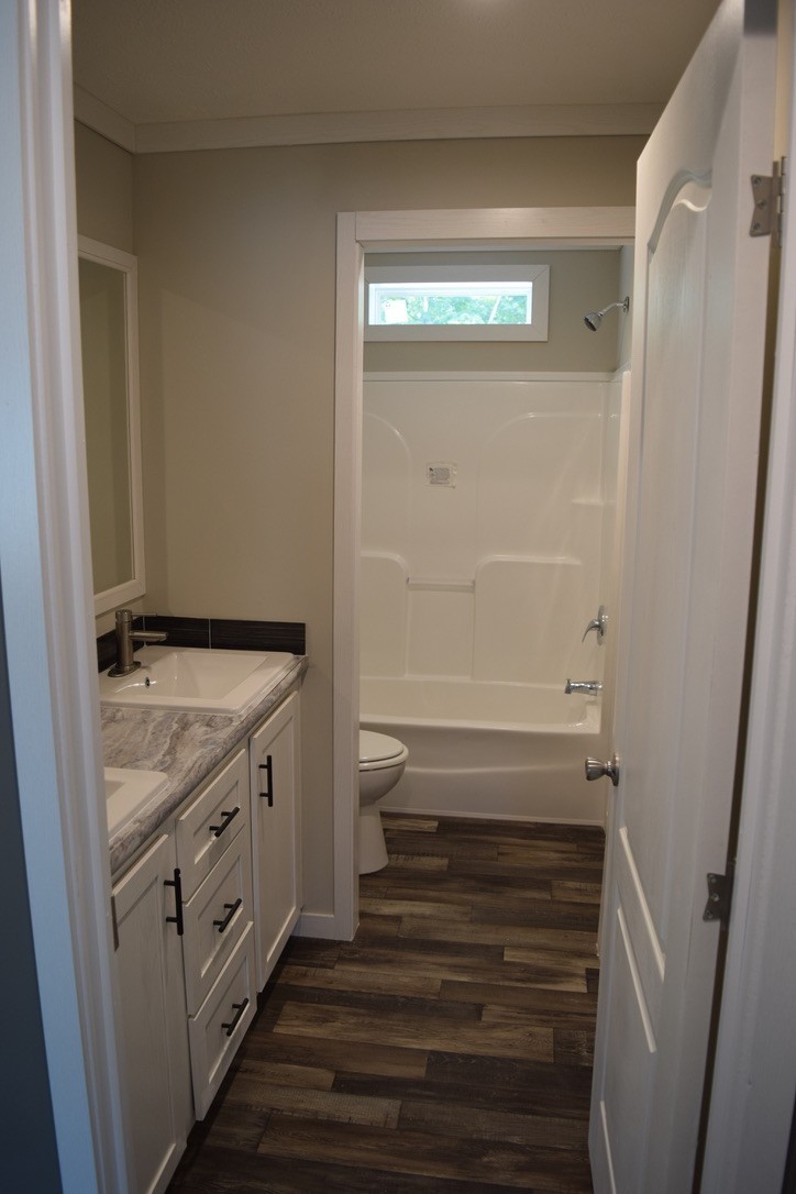 2166 Shrum Cemetery Road Westmoreland, TN 37186 - Photo 25 of 32 a bathroom with a sink and a mirror