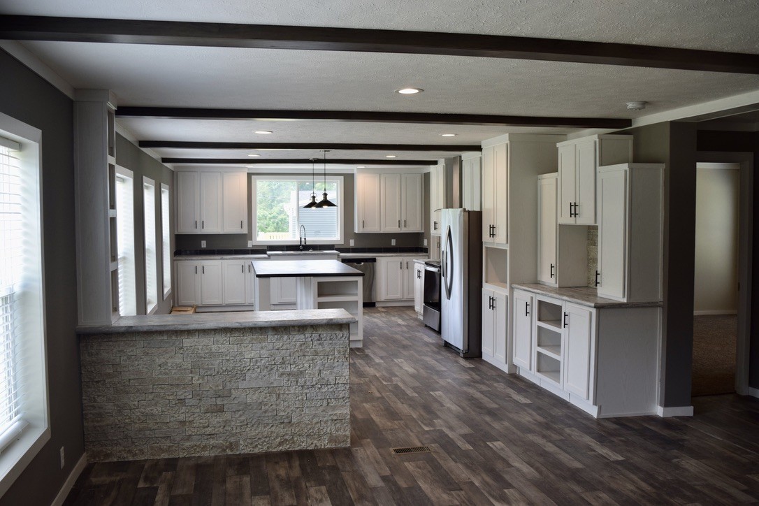 2166 Shrum Cemetery Road Westmoreland, TN 37186 - Photo 6 of 32 a kitchen with stainless steel appliances granite countertop a refrigerator and a stove