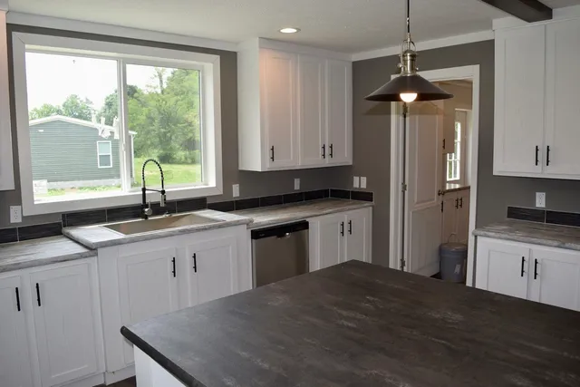 a kitchen with stainless steel appliances granite countertop a stove a refrigerator and a sink