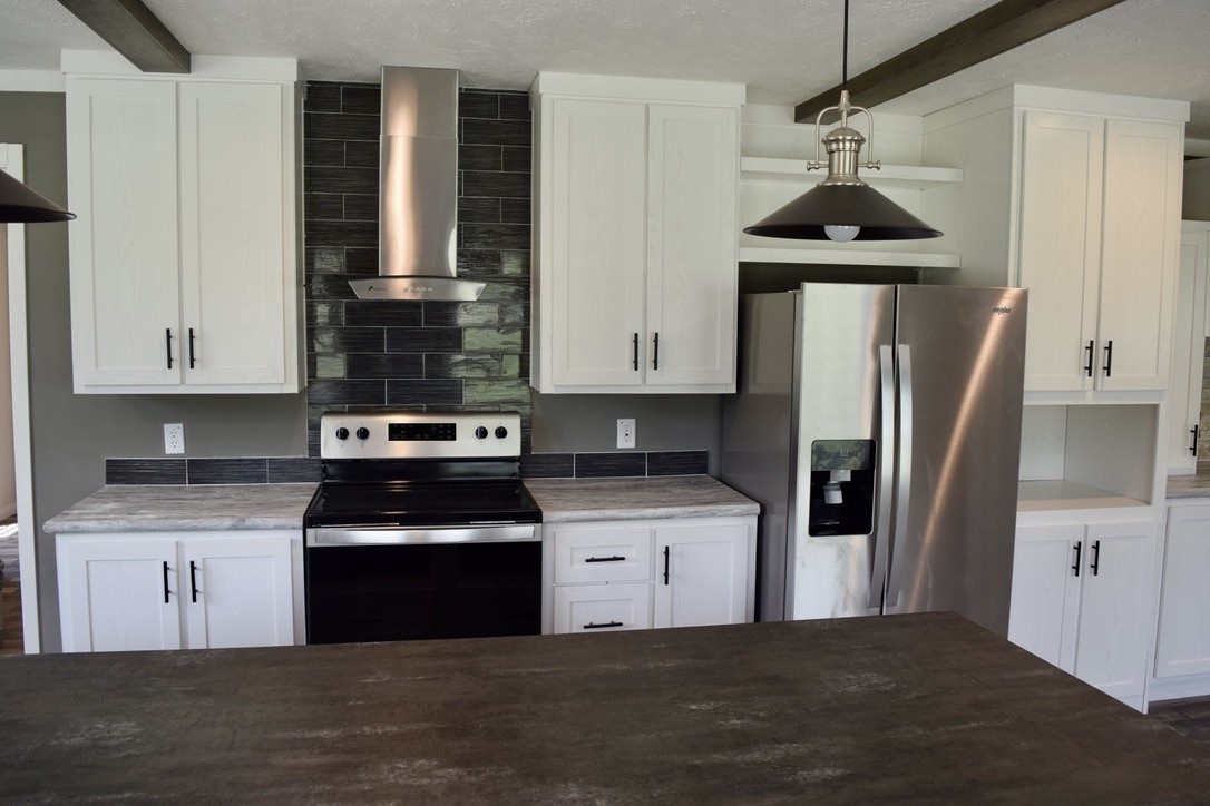 2166 Shrum Cemetery Road Westmoreland, TN 37186 - Photo 10 of 32 a kitchen with stainless steel appliances granite countertop a stove a refrigerator and a sink