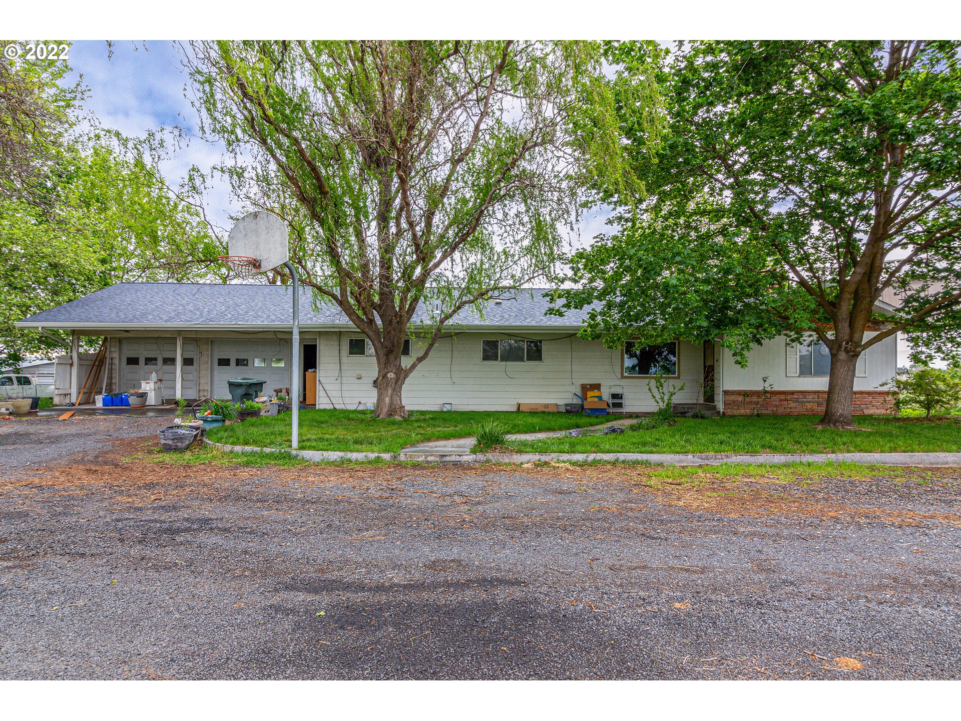 33225 West Spearman Road Hermiston, OR 97838 - Photo 1 of 32 a front view of a house with a yard and trees