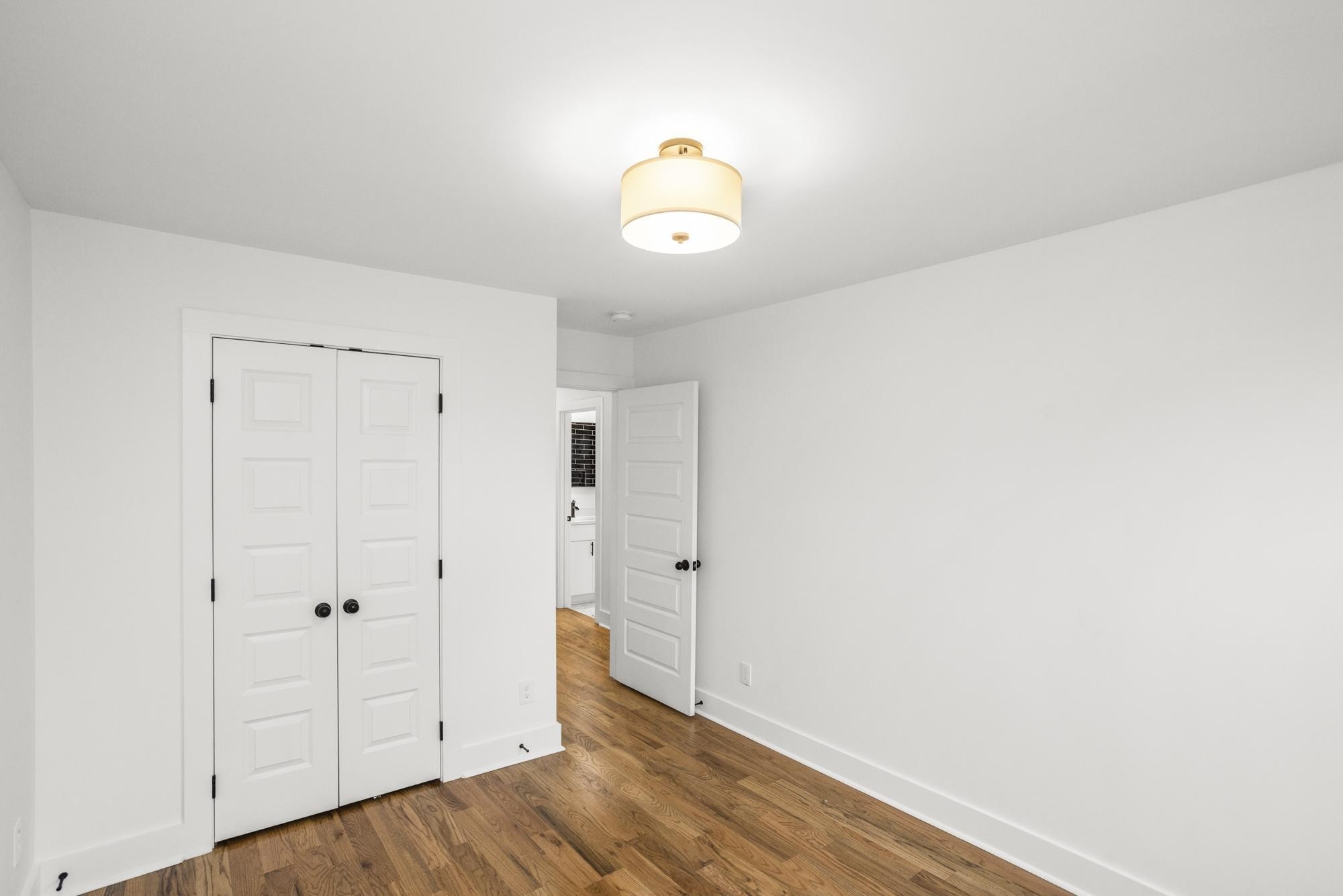 656 Chambers Street, Unit 140 Gallatin, TN 37066 - Photo 13 of 40 a view of an empty room with wooden floor