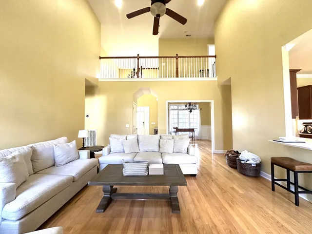 a living room with furniture and a chandelier
